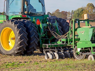 Tractor plowing with no till drill
