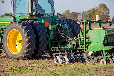 Tractor plowing with no till drill